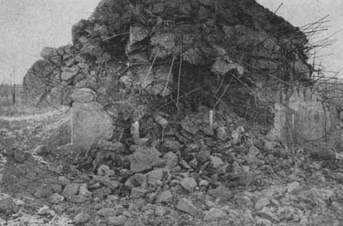 [Gun, 155 mm, M1A1, firing Shell, H.E., 155 mm, M101, with Fuze, CP, M78. Range using normal charge point blank range. View of damage to German-type reinforced concrete pillbox resulting from two rounds of shell.]